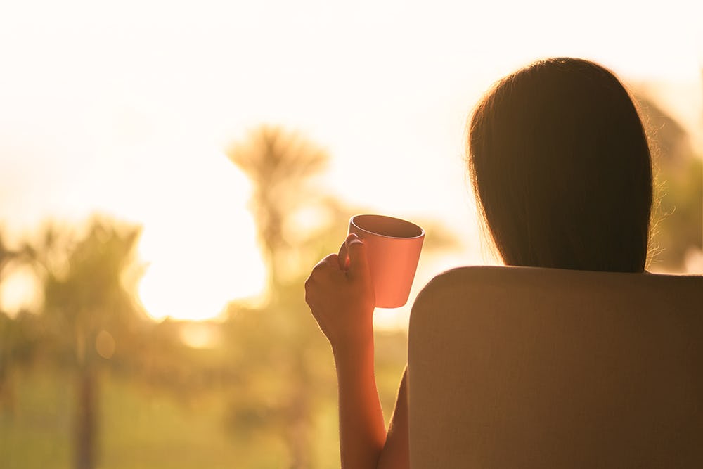Start the day drinking coffee while watching the sunrise over the lake